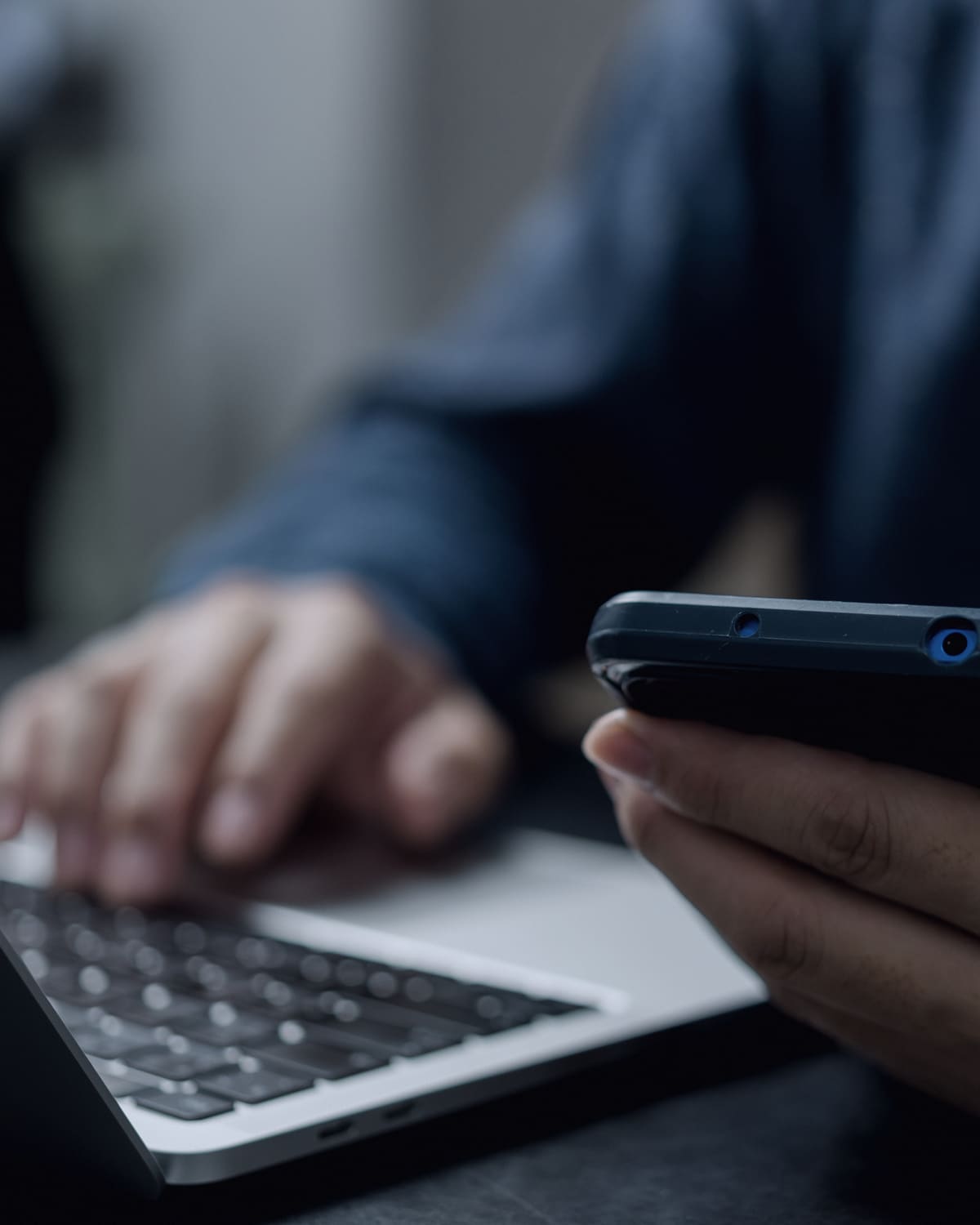 Examiner connecting a smartphone to a forensic imaging device