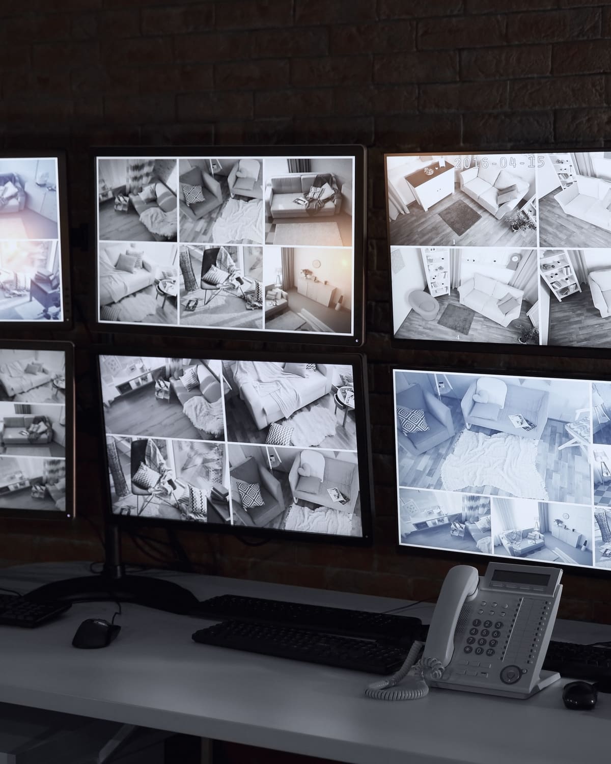 Security monitoring desk with a wall of camera feeds