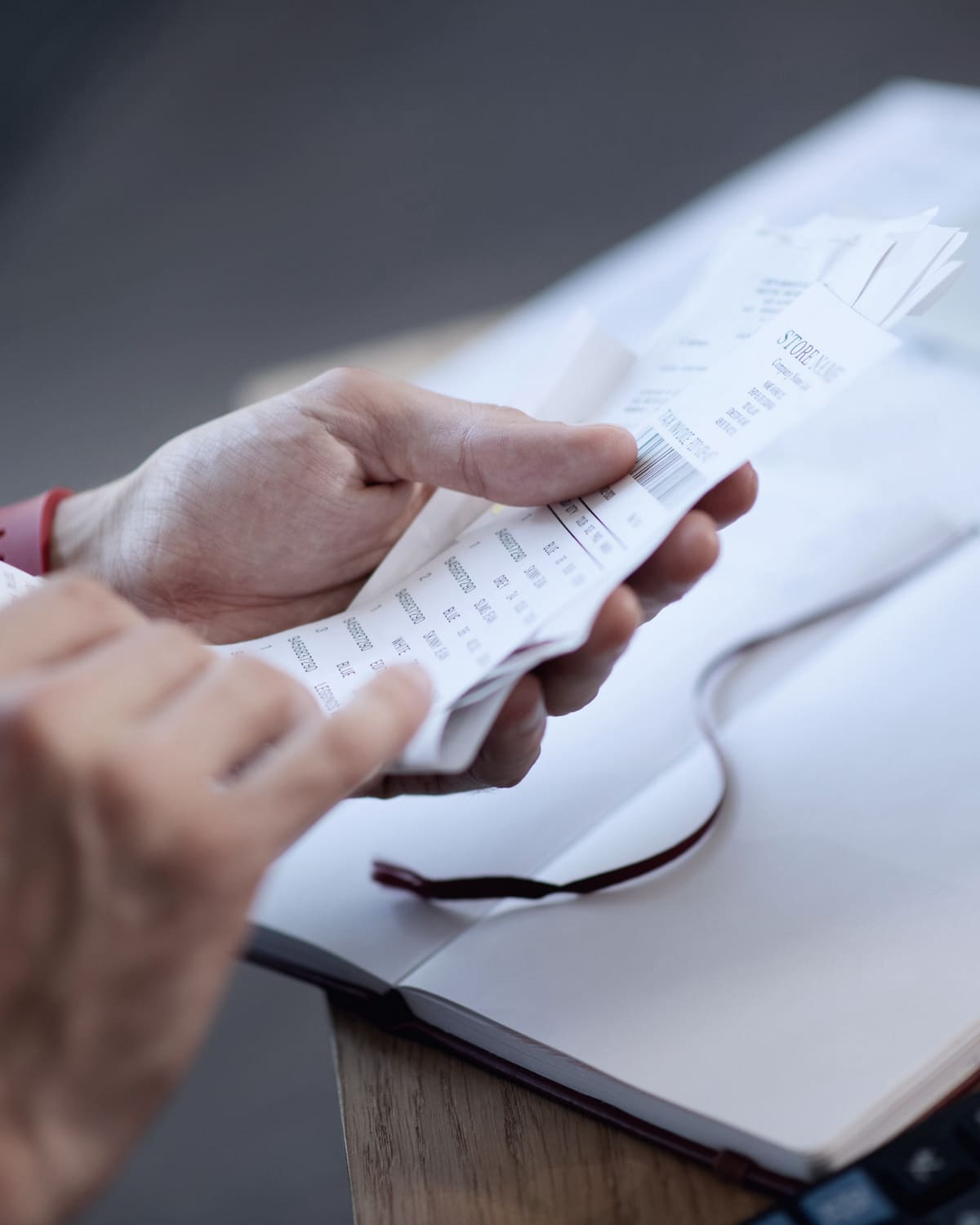Expense report, corporate card, and receipts on an executive desk