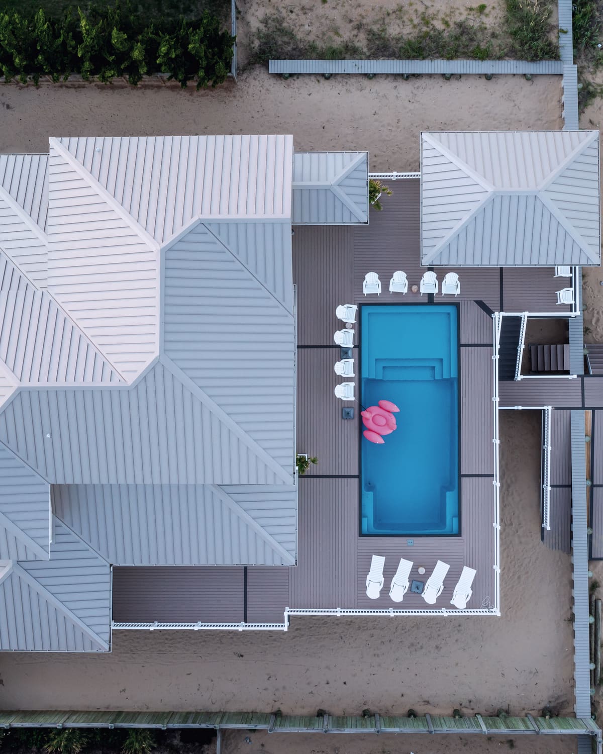 Aerial view of a waterfront home with a boat dock at dusk