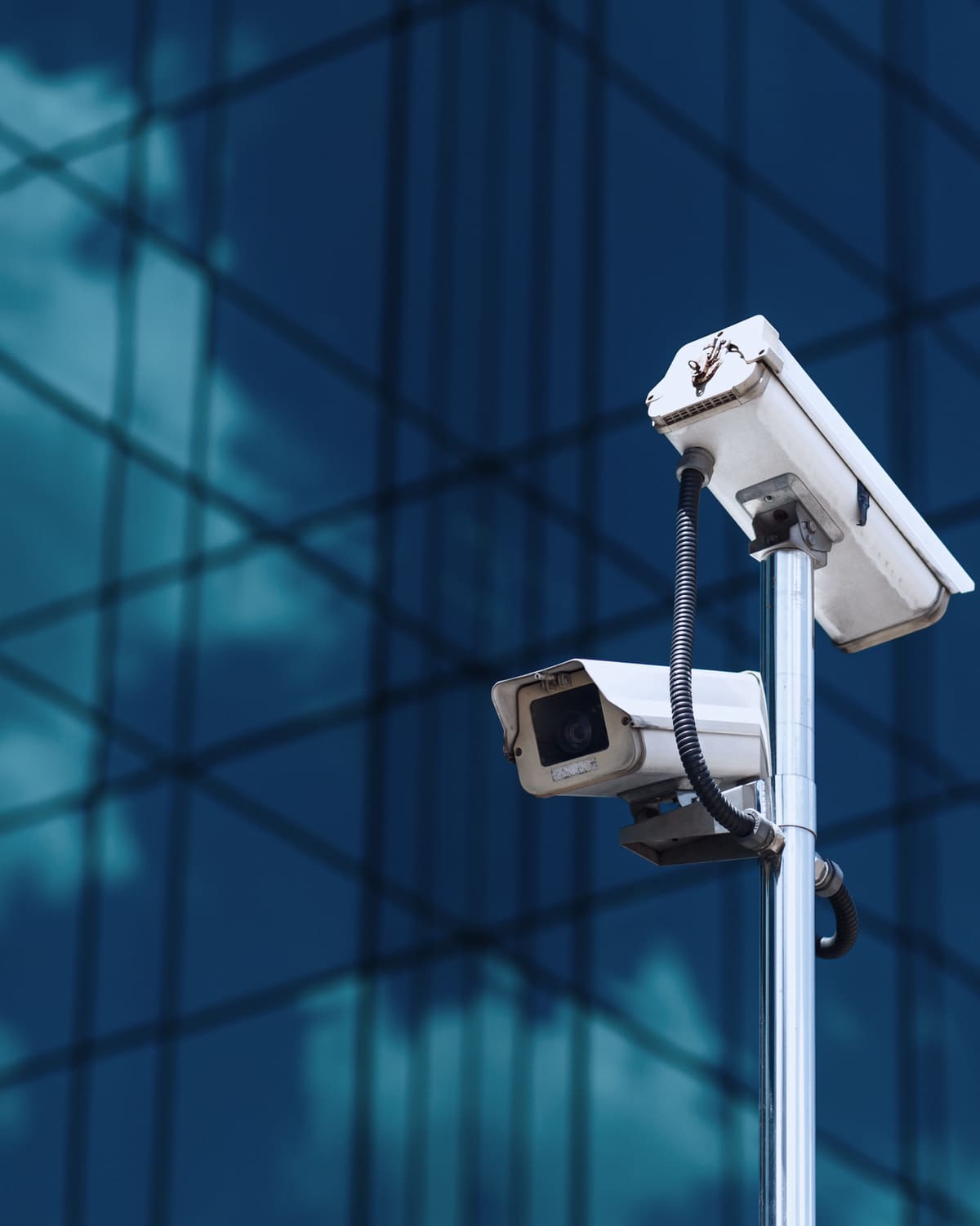 Security camera dome and card reader in a corporate corridor