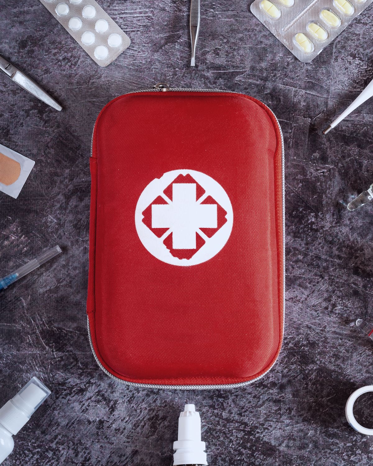Open trauma first aid kit with a tourniquet on a training table